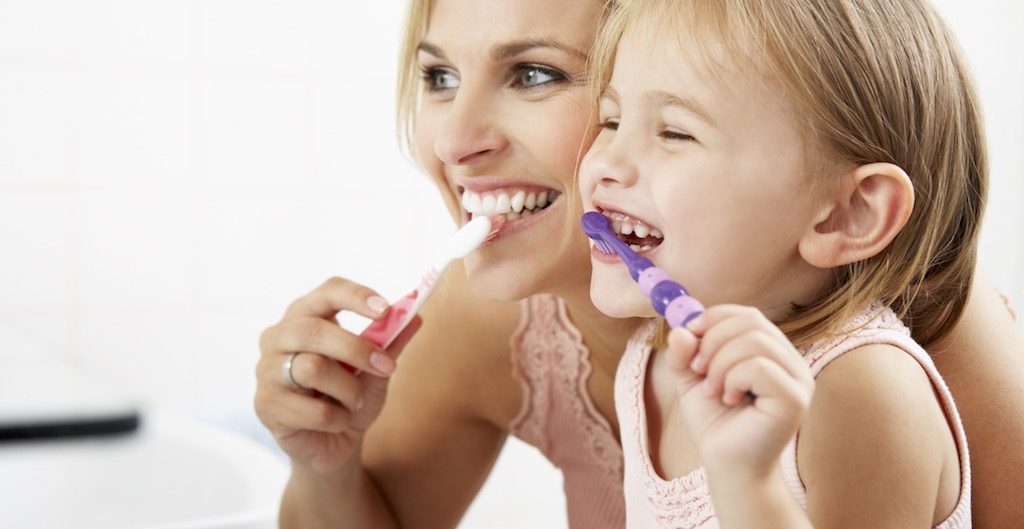smile forever mother and daughter brushing teeth